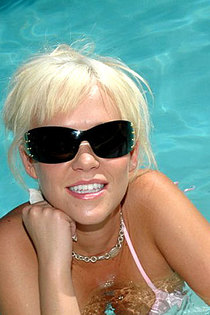 Blonde pornstar is sunbathing naked after swimming in the pool-10