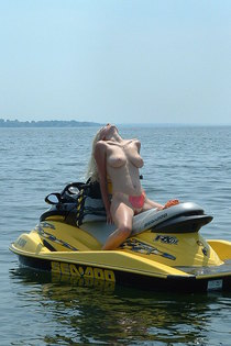 Naked blonde teen posing and spreading on skiboat-04